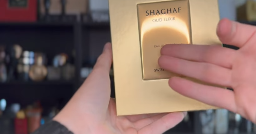 Close-up of Swiss Arabian Shaghaf Oud packaging texture and gold presentation box during fragrance review